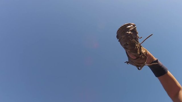 Baseball player reaching to make catch in slow motion