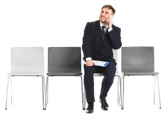 Young man waiting for job interview on white background
