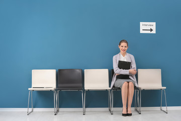 Young woman waiting for job interview, indoors