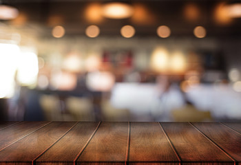 Wooden board empty table  cafe, coffee shop, bar blurred background can be used for display or montage your products and Mock up