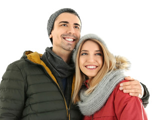 Young couple in warm clothing on white background. Ready for winter vacation