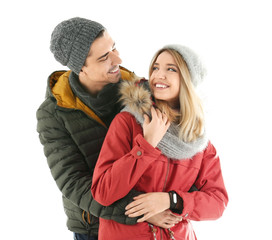 Young couple in warm clothing on white background. Ready for winter vacation