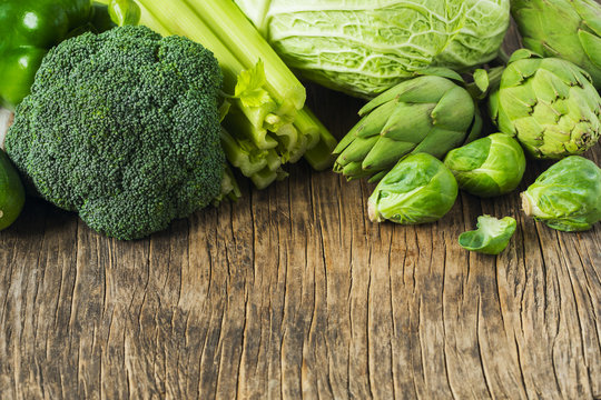 Green vegetables on a wooden background. Healthy food.