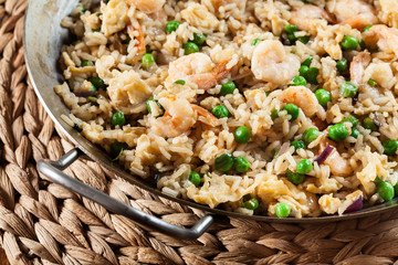 Fried rice with shrimp and vegetables on a frying pan
