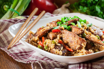 Fried rice with chicken and vegetables served on a plate