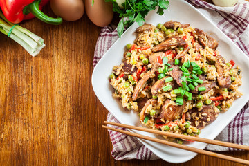 Fried rice with chicken and vegetables served on a plate