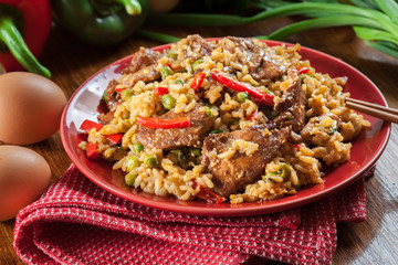 Fried rice with chicken and vegetables served on a plate