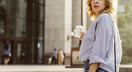 Closeup of woman with take away coffee