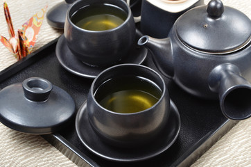 Obraz na płótnie Canvas Japanese style tea set in a wooden tray