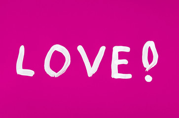 Love word painted on the pink background