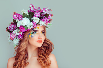 Naklejka premium Daydreaming young lady woman with floral headband from lilac flowers
