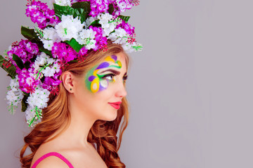 Fototapeta premium Beautiful young woman with floral lilac flowers headband in side profile