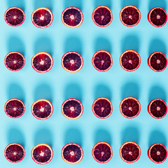 Fototapeta premium Red oranges on the bold blue background. Creative minimalism and modern food pattern concept