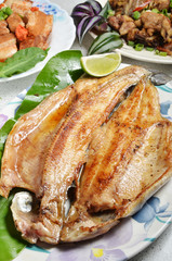 Pan fried trout with  lemon on plate