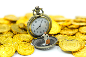 Miniature people : Businessman look a watch with Vintage Pocket watch on gold coins.