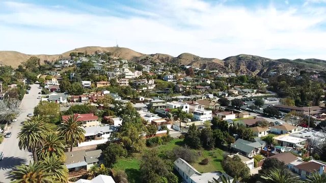 Drone Flyover - Ascending view over Ventura, California beach town with church in background