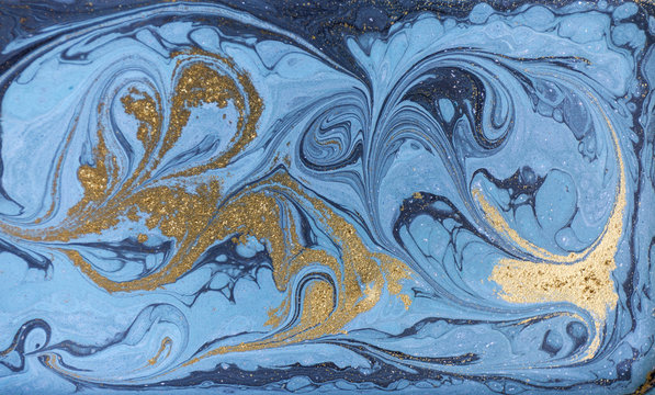 Marble abstract acrylic background. Nature blue marbling artwork texture. Gold glitter.