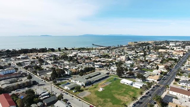 Aerial Flyover Panning Backward - Southern California coastal town with islands in the distance