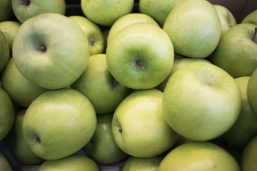 Bunch of green apples in supermarket