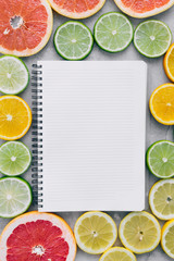 Top view Flat lay notebook sliced citrus fruit Summer background