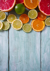 Fototapeta na wymiar citrus fruit slices on turquoise background