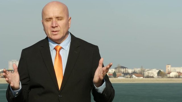 Businessman Talking in TV Reportage Presenting and Explaining Financial Issues