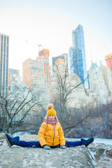Adorable little girl with view of ice-rink in Central Park on Manhattan in New York City