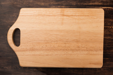 Empty vintage cutting board on planks food background concept