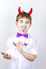 Cheerful Boy with red horns April fool's day.