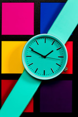 Clock on a  colored background. Abstraction. Minimalism