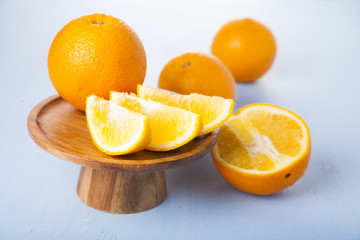 Oranges on a wooden plate