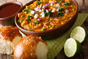 Pav Bhaji Indian spicy fast food with bread Paav close-up on the table. Horizontal