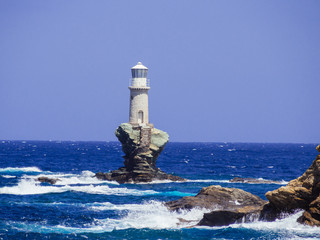 The white lighthouse of Andros island, in the Cyclades, Greece.