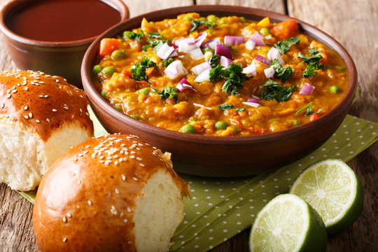 Pav bhaji - popular Indian street food close-up in a bowl. Horizontal