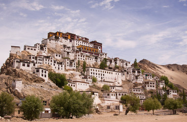 Scenic view on ancient buddhist monastery in himalayas with cloudy blue sky background. Region Ladakh. State Jammu and Kashmir. India.