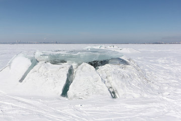 Fototapeta na wymiar Ice breaking on the river in early spring, Ob reservoir, Russia