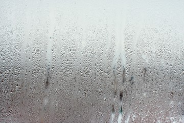 Water droplets condensation background of dew on glass window, humidity and foggy blank background....