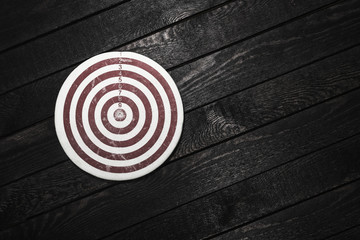 Dart on wooden background