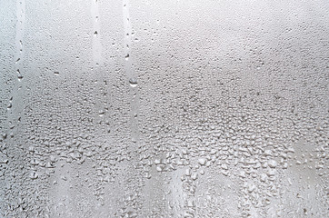 Texture of a drop of rain on a glass wet transparent background. Toned in grey color - obrazy, fototapety, plakaty