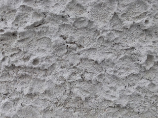 Gray convex stone wall texture closeup