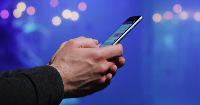 4k Close-up of a man's hand using smartphone in the oceanarium