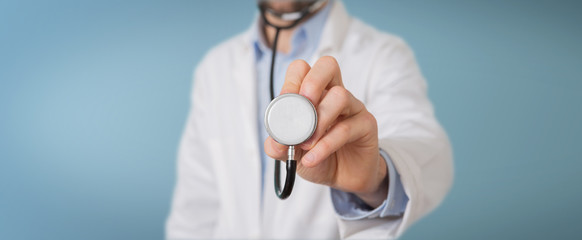 Doctor using stethoscope in hospital