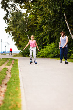 Young people casually rollblading together.