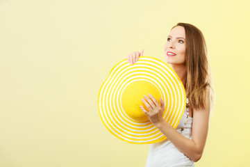 Woman in big yellow summer hat.