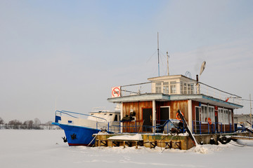 landing stage / landing stage and a boat are frozen into ice, Volga river, Uglich, Yaroslavl region, Russia