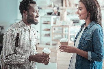 Pleasant communication. Happy positive nice people having coffee and talking to each other while enjoying their communication