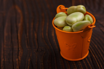 fresh broad beans on a rustic background