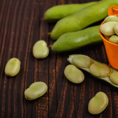 fresh broad beans on a rustic background