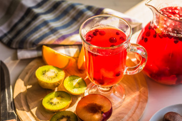 A traditional Scandinavian drink with cranberries and berries in a glass and jug