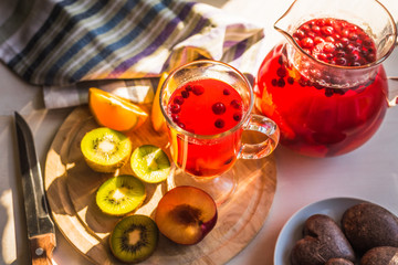 Vegetarian breakfast - fruits with pastries and a drink of cranberries and berries on a rustic background, in the morning